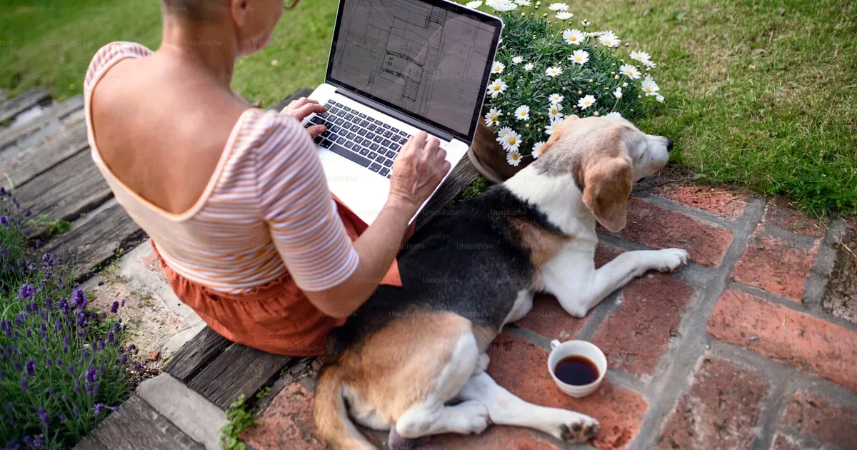 Filipino virtual assistant working part-time from a home office with a laptop and coffee