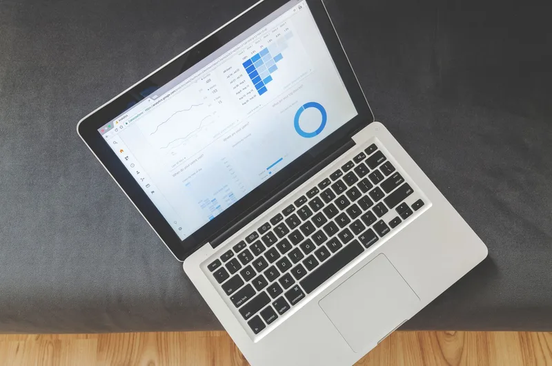 Laptop screen showing data visualizations and analytics charts for digital marketing reporting