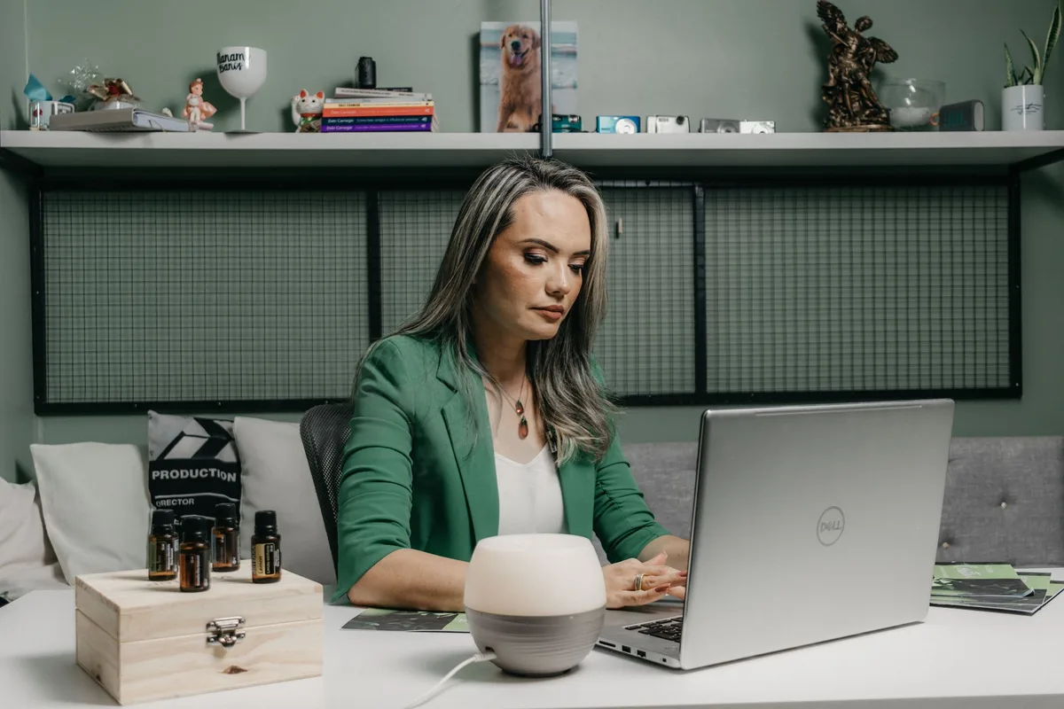Virtual assistant working on a laptop at a home office desk