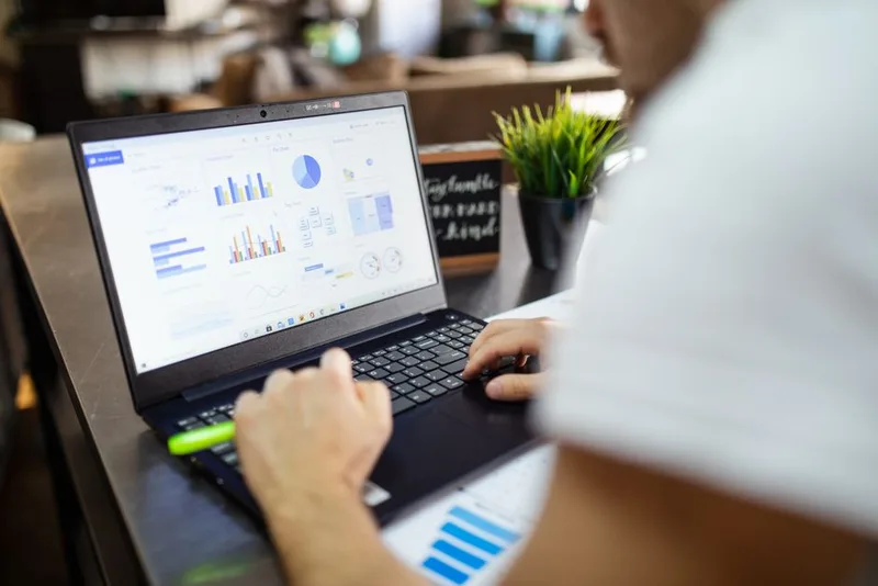 Laptop screen showing colorful charts and graphs on a business dashboard