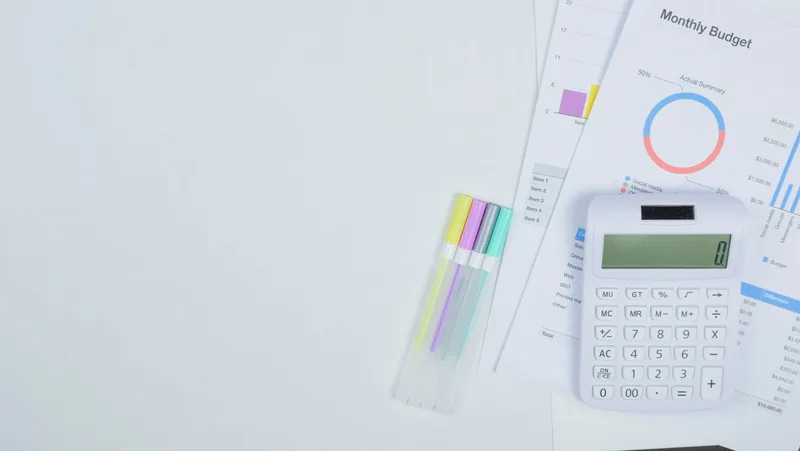 Calculator and budget planning documents on a desk