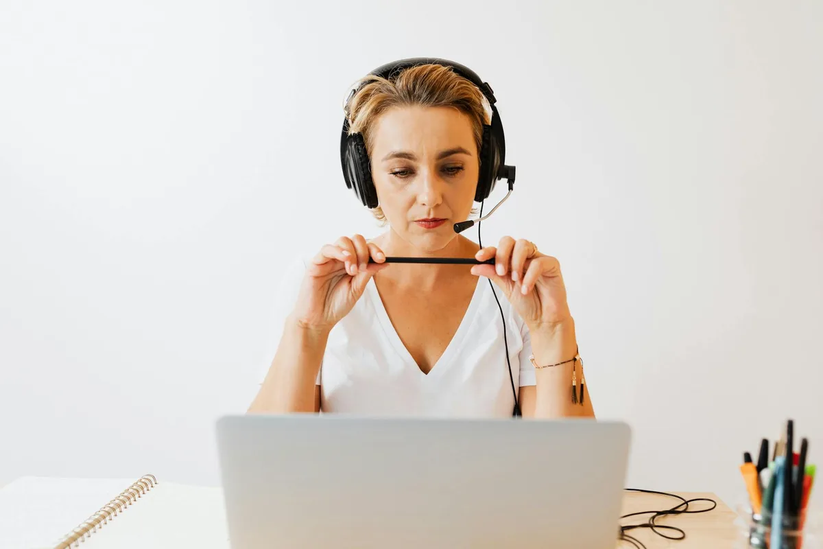 Filipino woman doing virtual assistant work from home on a laptop in a bright home setup