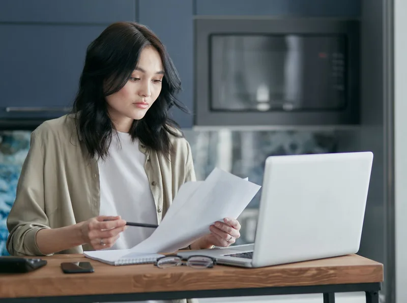 Person carefully reading through a job listing on a laptop before applying