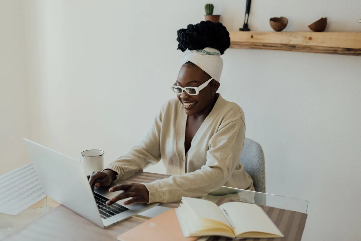 Filipino virtual assistant reviewing job listings on a VA portal from a home office laptop