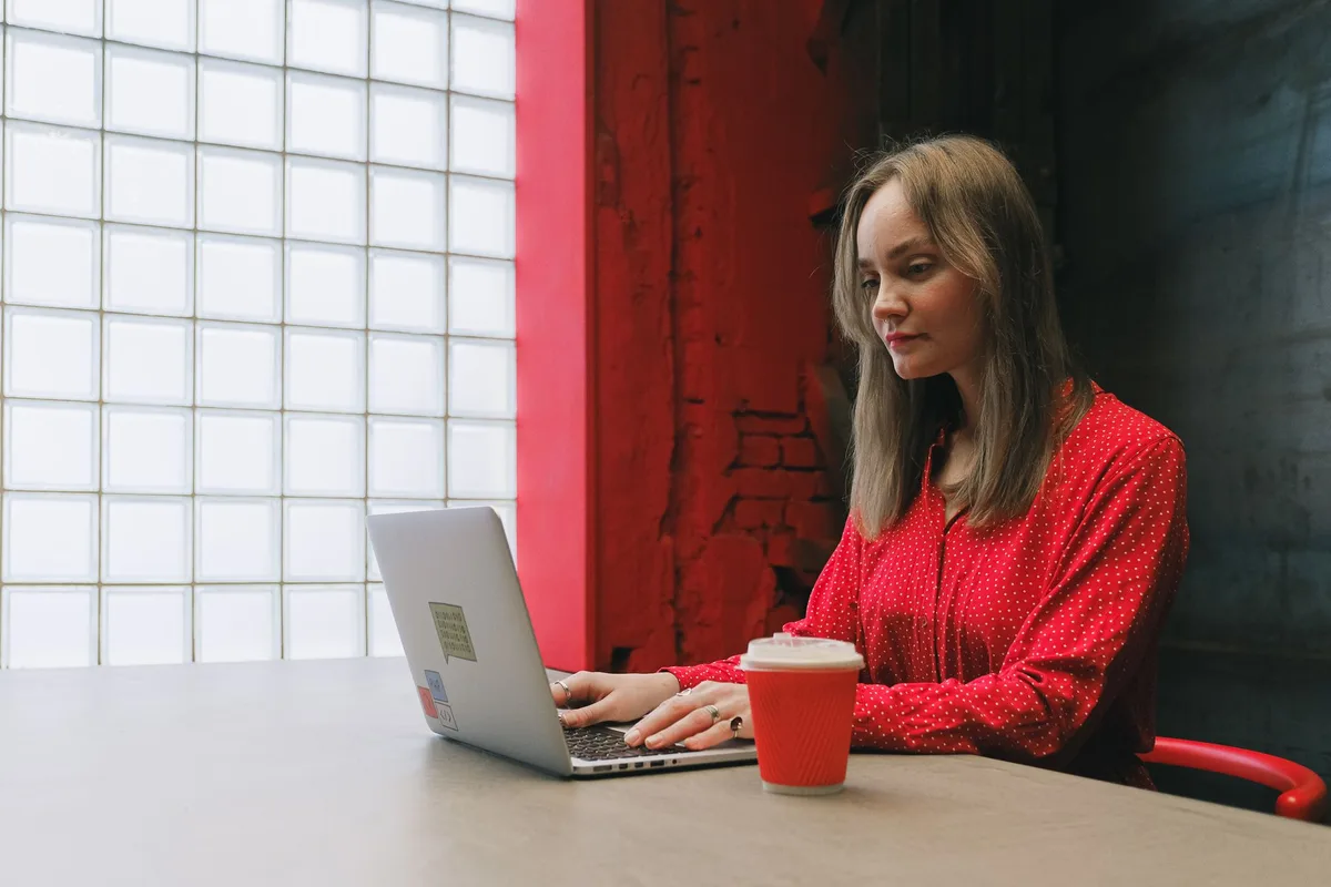 Filipino woman working online as a virtual assistant from home on a laptop