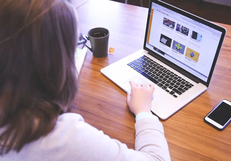 Person searching for online VA work on a laptop from home