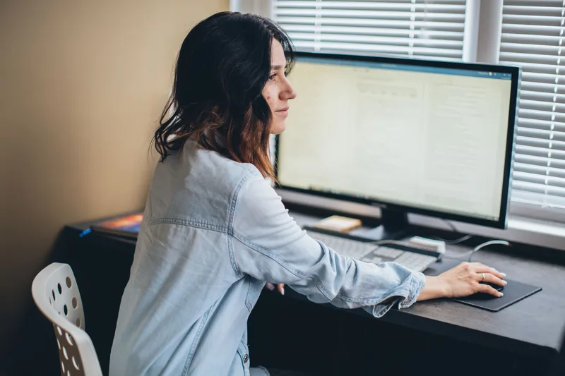 Home office workspace setup with laptop for virtual assistant work